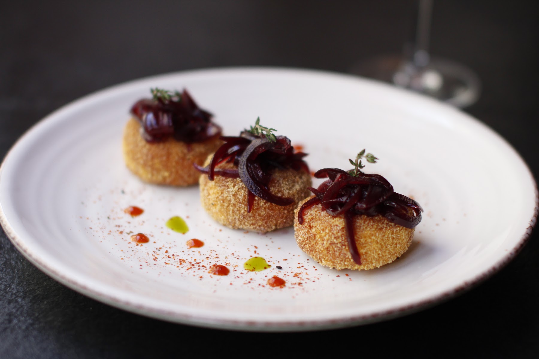 fried balls with caramelized onions